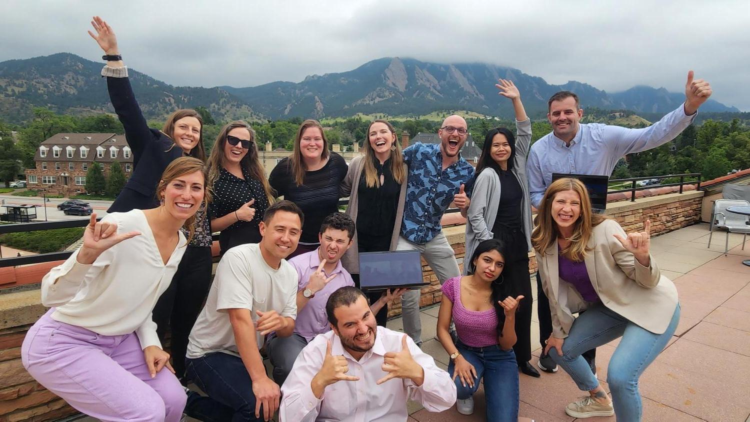 HGV Fellows on balcony with Flatirons in the background