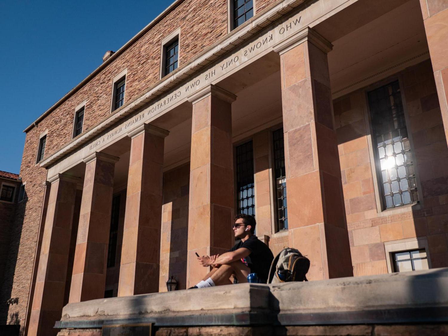 Student sitting in front of Norlin Library