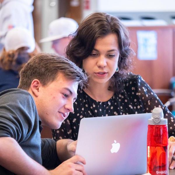 Students looking at laptop