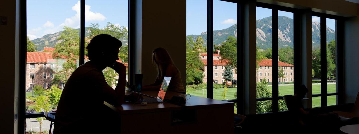 Silhouette of a student studying on campus